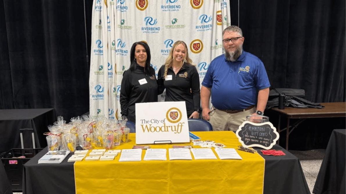 Bekki Phillips, Mary-Margaret Bowen, and Zach Parton stand behind the City of Woodruff booth at the OneSpartanburg Internship Fair, promoting public service internship opportunities.